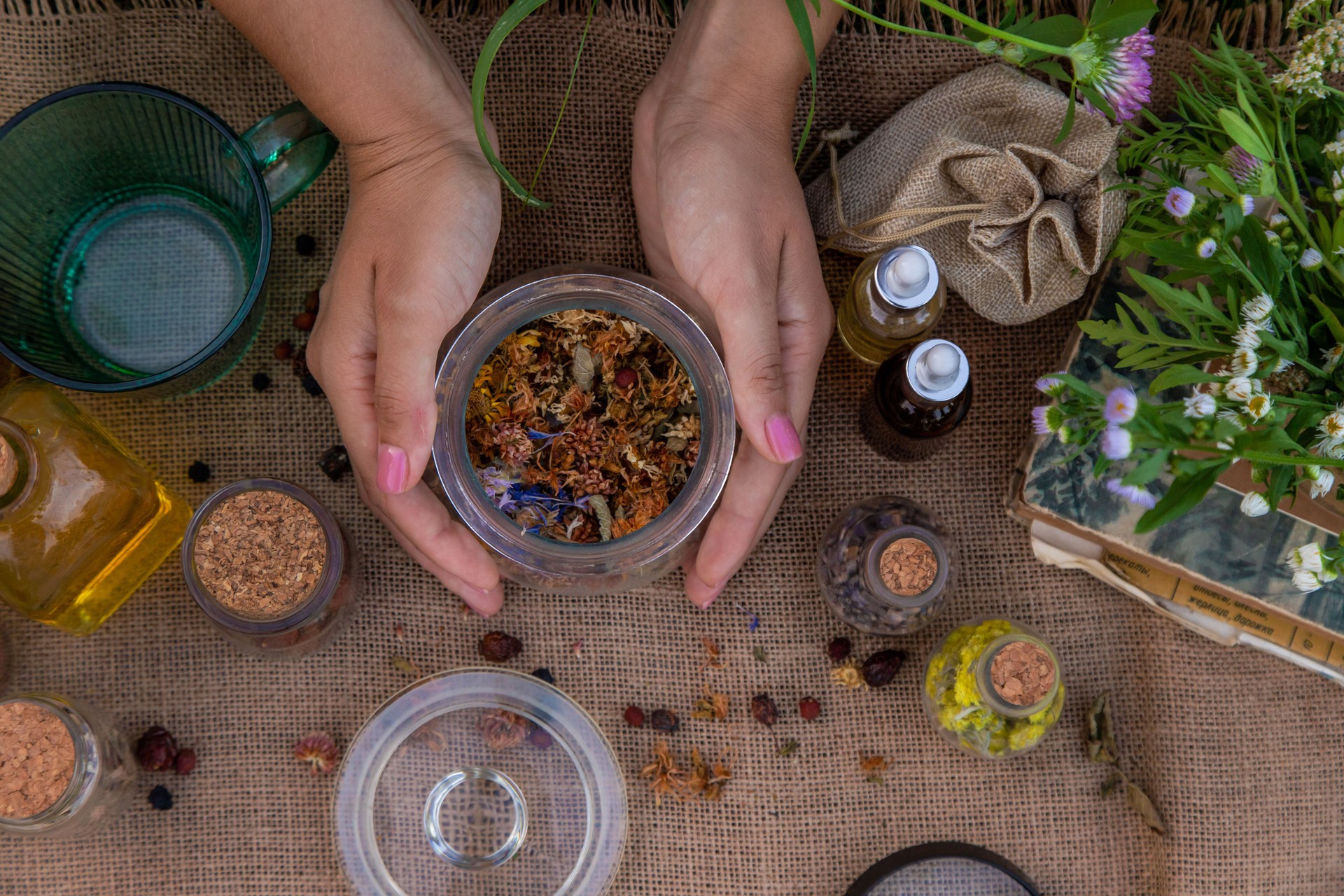 woman and herbal tinctures, tea, medicinal herbs.