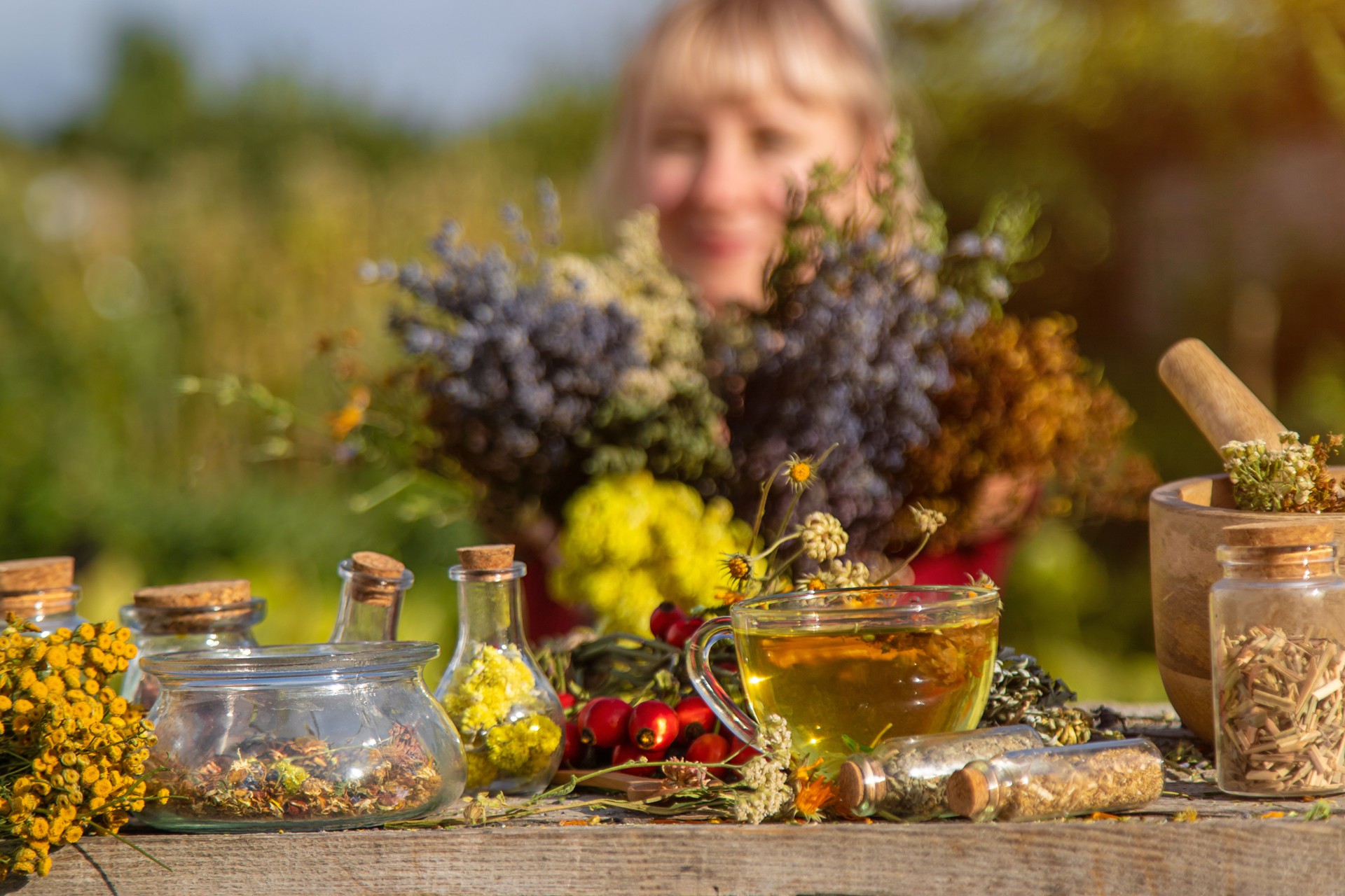 A woman brews herbal tea. Selective focus.